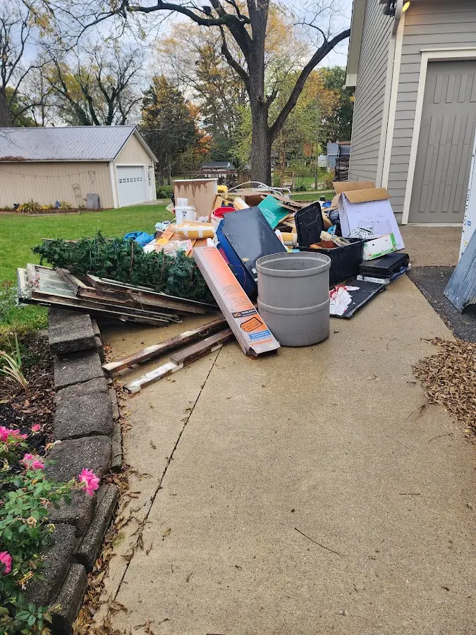 Dumpster being loaded with debris for Roofing Dumpster Rental in Amelia